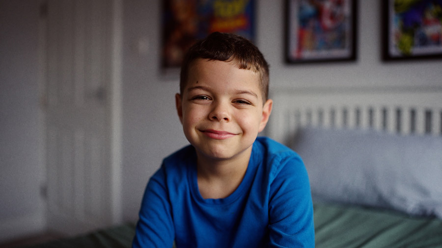 A young boy smiling at the camera.