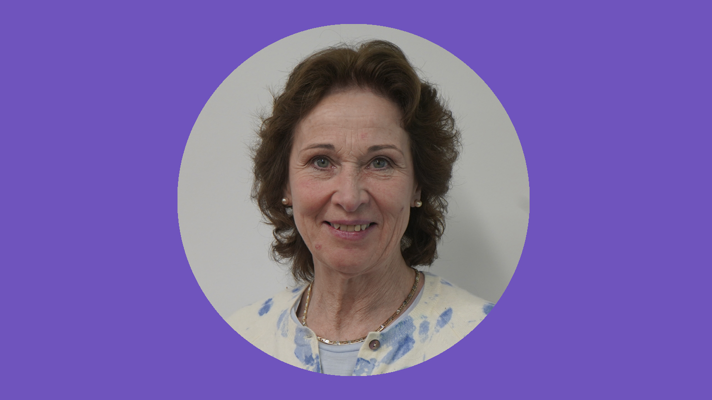 A woman smiles at the camera