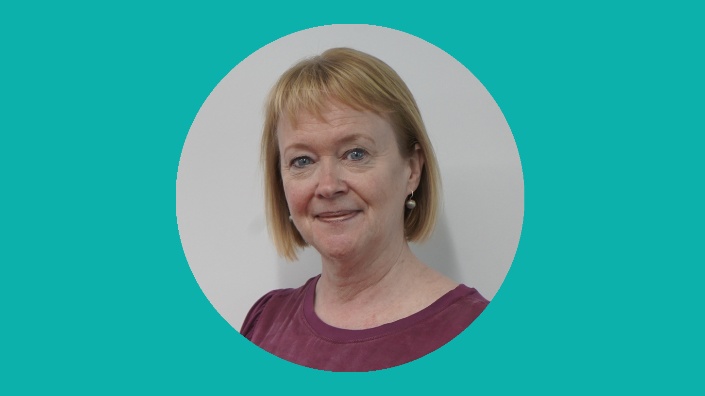 A woman smiles at the camera