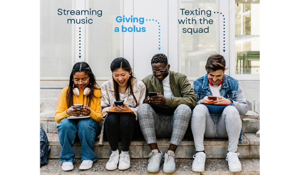 4 young adults sat on their phones. An arrow pointing to one saying 'streaming music' one pointing to another saying 'texting with the squad' and one pointing to someone saying 'giving a bolus'