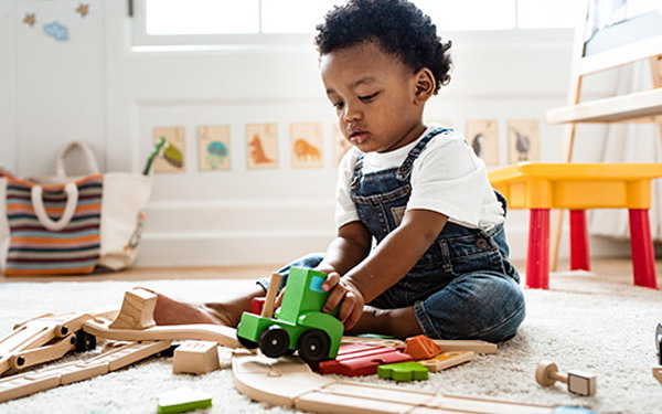 Toddler sat playing with toys