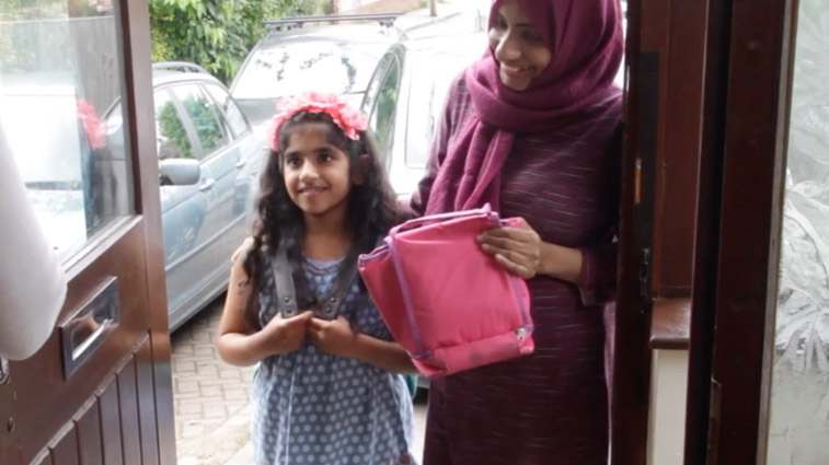 A girl and her mum at the front door