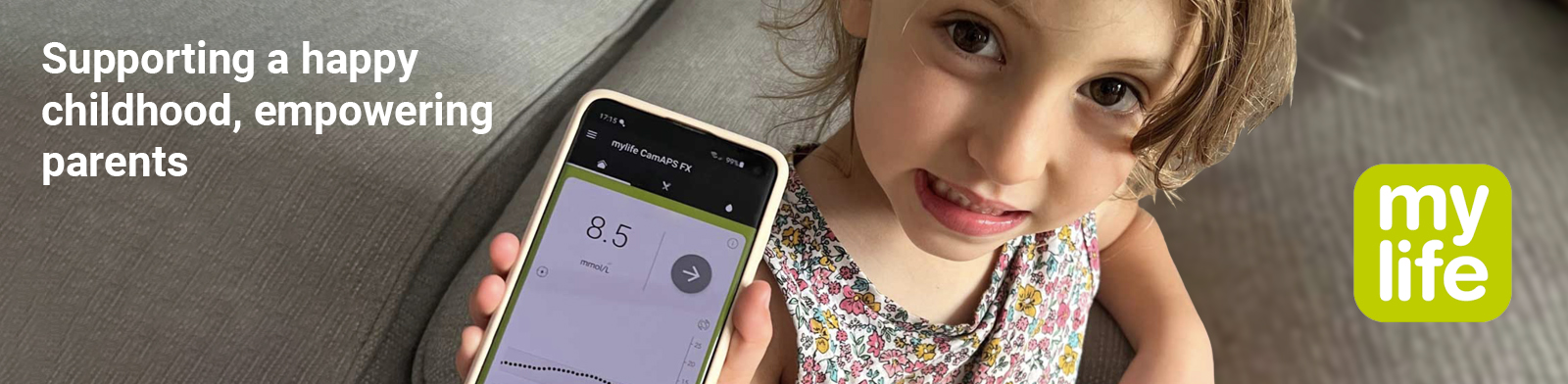A girl is holding up a phone showing her glucose reading. The image reads, 'Supporting a happy childhood, empowering parents', and 'Mylife loop for young people.'