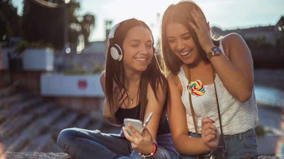 two teens listening to music