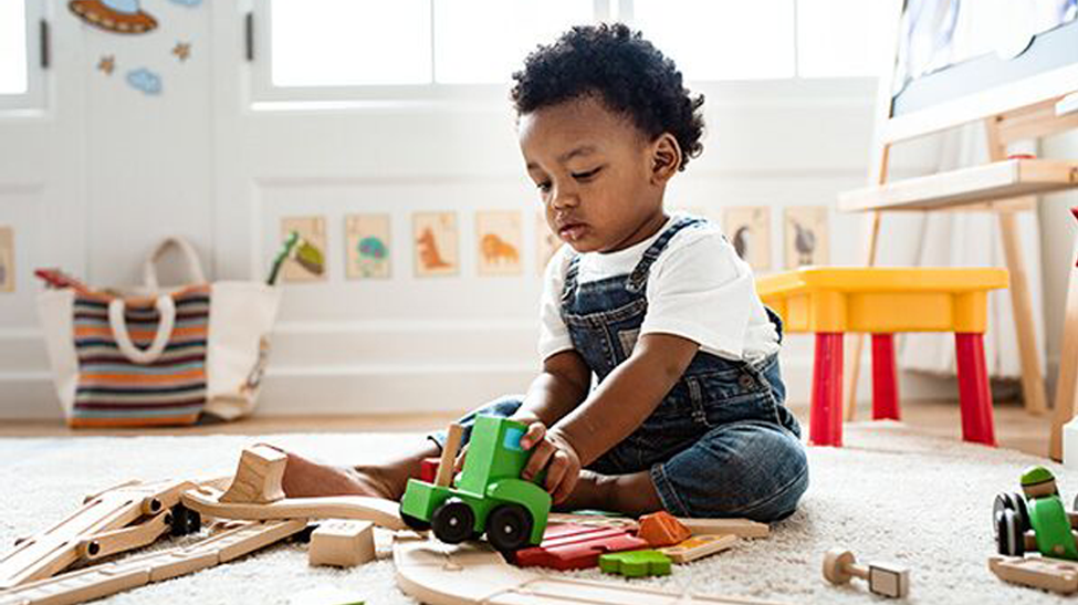 Toddler sat playing with toys