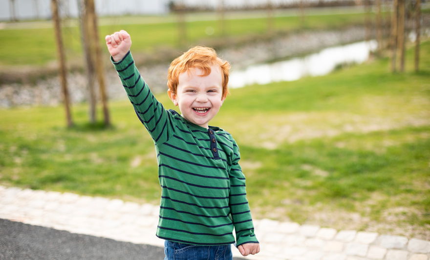 happy child with his arm in the air